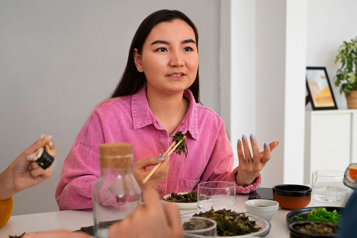 Woman asks boyfriend to respect chopstick etiquette, sparking a discussion about cultural respect at dinner. Woman asks boyfriend to respect chopstick etiquette, sparking a discussion about cultural respect at dinner.