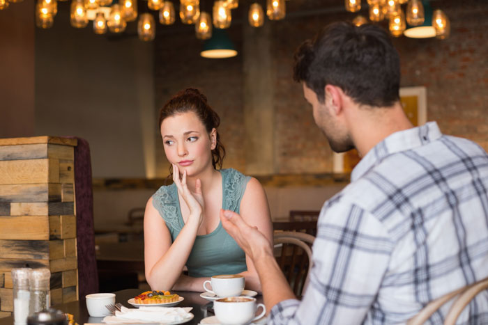 A woman looks upset while her boyfriend talks to her, reflecting on why deleting her phone app hurt so much. A woman looks upset while her boyfriend talks to her, reflecting on why deleting her phone app hurt so much.