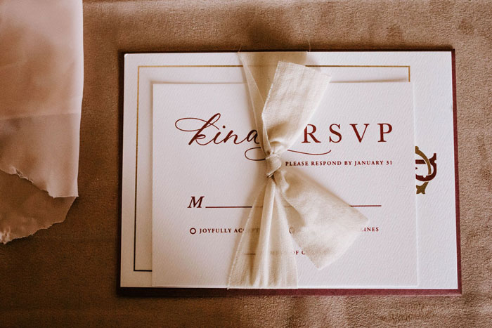 Elegant wedding RSVP card, tied with a ribbon, relating to the groom's sisters and bridesmaid dresses issue. Elegant wedding RSVP card, tied with a ribbon, relating to the groom's sisters and bridesmaid dresses issue.
