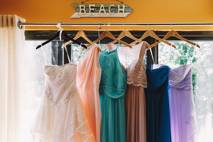 A row of colorful bridesmaid dresses hanging in a window, hinting at a groom's promise and a bride's weight-based rejection. A row of colorful bridesmaid dresses hanging in a window, hinting at a groom's promise and a bride's weight-based rejection.
