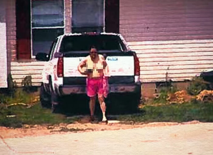 A pixelated image of the worst neighbor ever, a man mowing his lawn shirtless before a fatal incident.