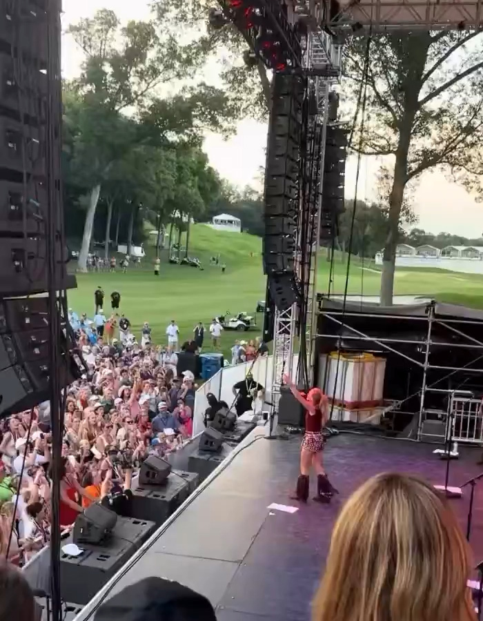 Carrie Underwood performs for a crowd at a golf course, facing taunts.