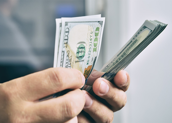 Close-up of hands counting money, suggesting the importance of finances for a famous model. Close-up of hands counting money, suggesting the importance of finances for a famous model.