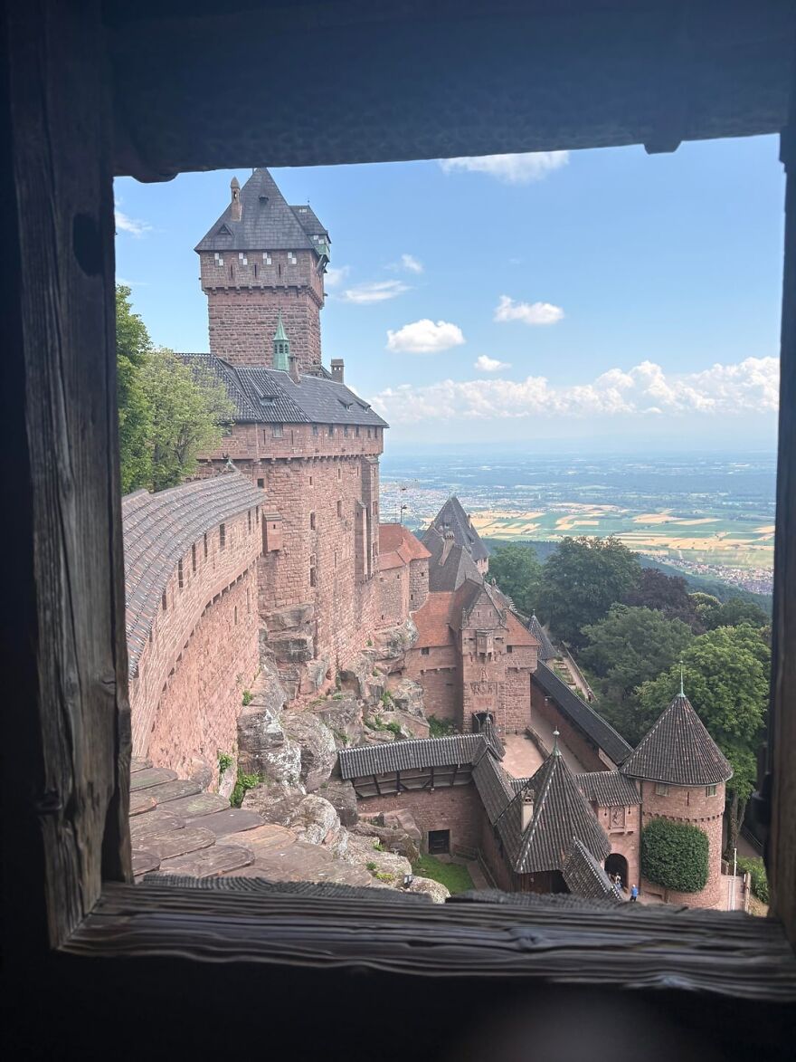 Interesting view of a beautiful castle from a window, showcasing its intricate architecture and vast landscape.