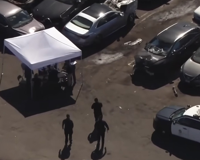 Overhead view of a crime scene with a white tent, police cars, and damaged vehicles, related to D4vd's relationship. Overhead view of a crime scene with a white tent, police cars, and damaged vehicles, related to D4vd's relationship.