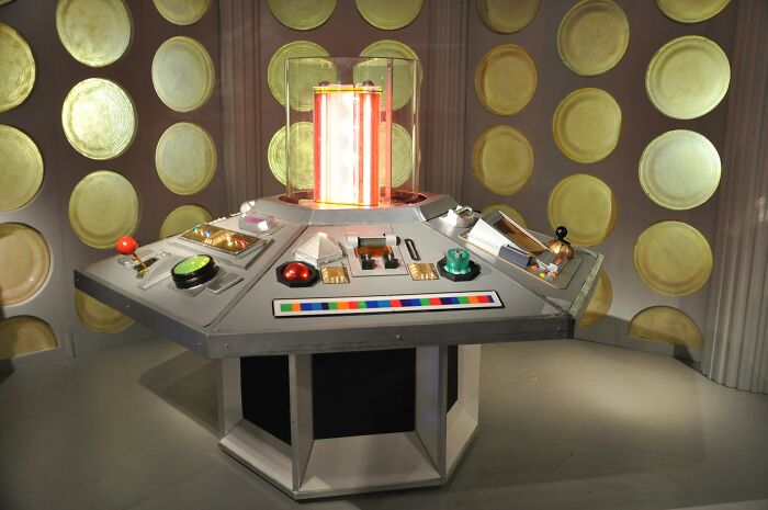 A detailed view of the console from a science fiction show, highlighting complex controls and a central illuminated column for mansplaining examples.