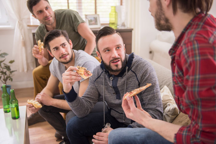 A group of friends enjoys pizza and drinks, one guy refuses to expose acquaintance's cheating GF, surprising friends.