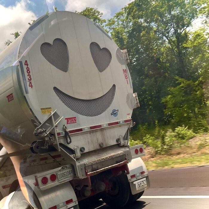 A truck with a smiley face and heart-shaped eyes on its back, a brilliant design transforming ordinary things.
