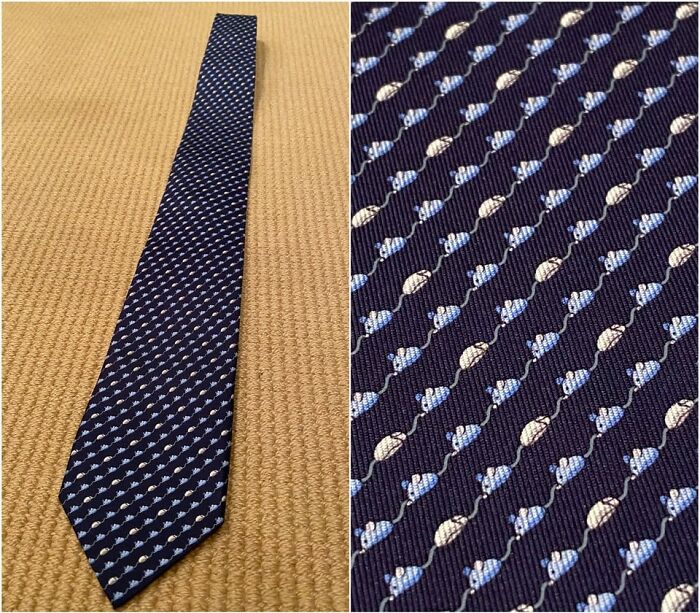 A navy tie with a pattern of small mice, a brilliant design transforming an ordinary accessory.
