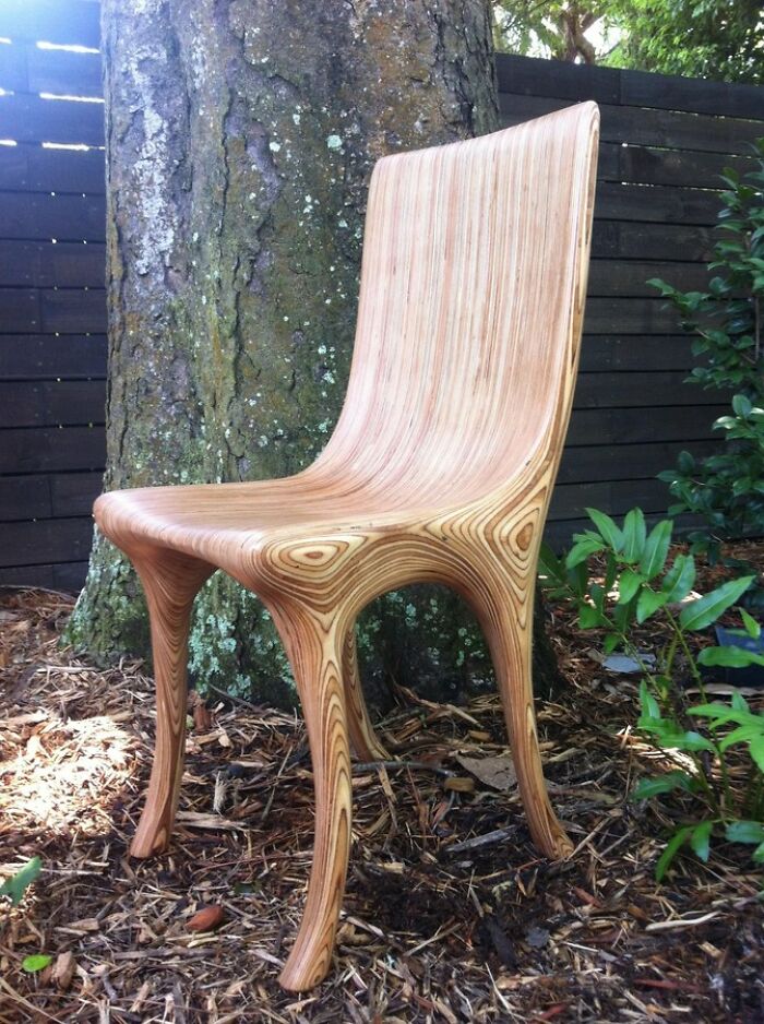A uniquely designed wooden chair with a flowing grain pattern, a brilliant transformation of an ordinary chair.