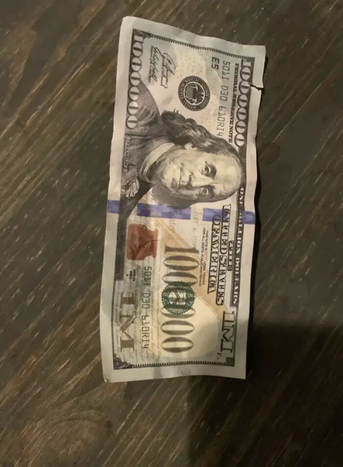 A fake million-dollar bill, showing a customer's rude gesture towards service industry workers.