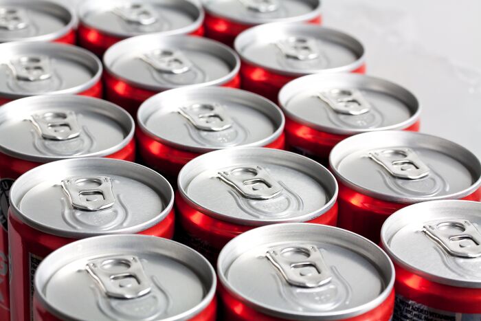 Rows of red soda cans, representing everyday complaints from men with partners.
