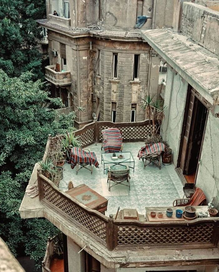 An iconic outdoor furniture setup on a rooftop terrace, part of a remarkable historic building design.