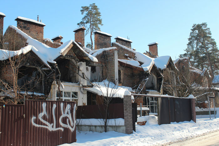 Snow-covered damaged buildings highlight the widespread destruction after nuclear war.