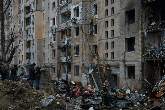 Damaged apartment buildings after nuclear war, showing the destruction and debris of a war-torn urban area.