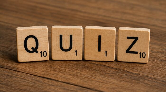 Scrabble tiles spelling QUIZ on a wooden surface, representing a language IQ challenge to name words ending in '-ANT'. Scrabble tiles spelling QUIZ on a wooden surface, representing a language IQ challenge to name words ending in '-ANT'.