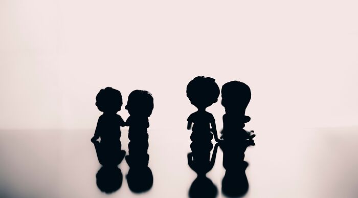 Silhouette of figures representing a missing celebrity, ideal for guessing games in pop culture.