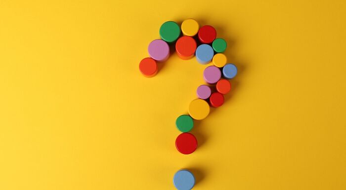 A question mark formed by colorful circular blocks on a yellow background, representing a 1% Club Brain logic challenge. A question mark formed by colorful circular blocks on a yellow background, representing a 1% Club Brain logic challenge.