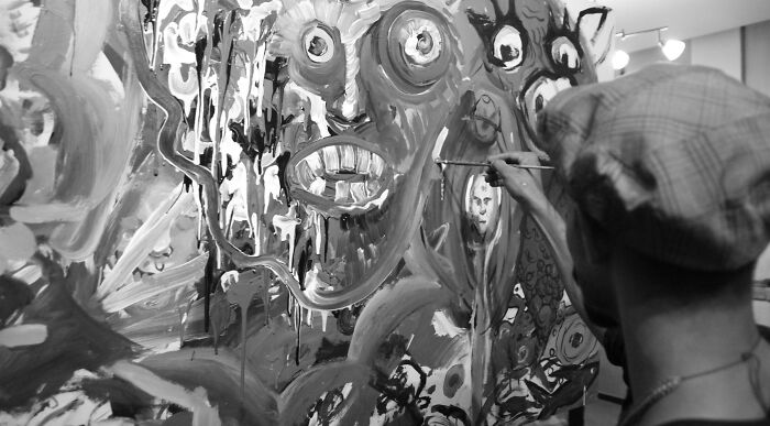 Black and white image of an artist painting a Picasso or Van Gogh style artwork on a canvas. Black and white image of an artist painting a Picasso or Van Gogh style artwork on a canvas.