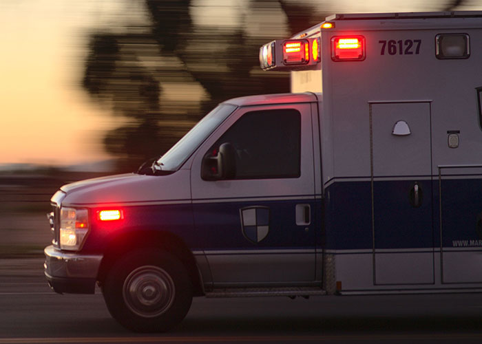 An ambulance speeding with lights flashing, reminiscent of unhinged job interview stories.