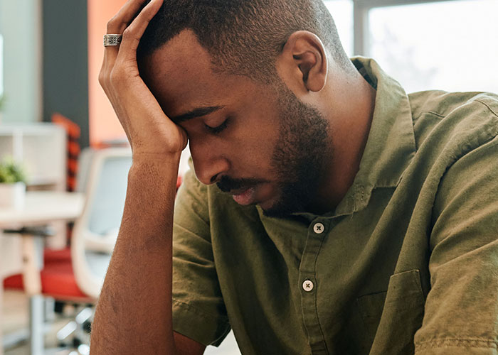 Man looking stressed, reflecting the pressure of job interview stories.