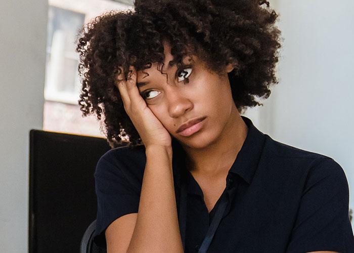 A young woman with a tired expression, embodying the range of job interview emotions.