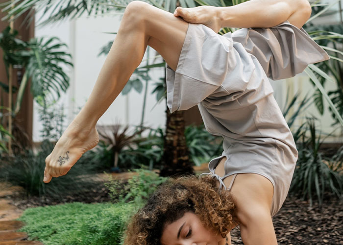 Woman in a yoga pose, demonstrating a flexible job interview approach.