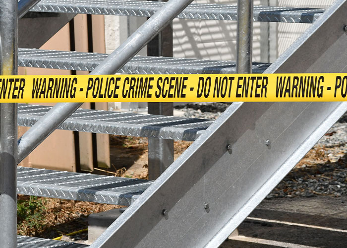 Police crime scene tape on metal stairs, signifying unhinged job interview stories.