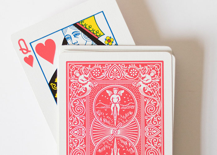 A playing card deck with the Queen of Hearts on top, representing job interview stories.