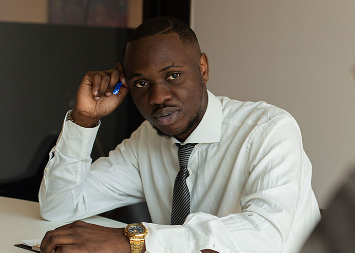A man in a shirt and tie looking thoughtful, symbolizing a serious job interview experience.