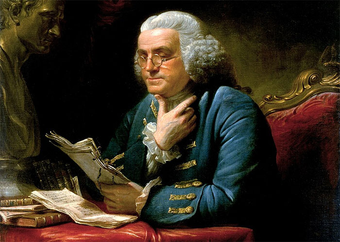 Painting of Benjamin Franklin reading, representing a key figure and facts about America's past.