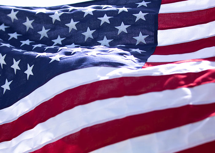 Close-up of a waving American flag, representing iconic America facts.