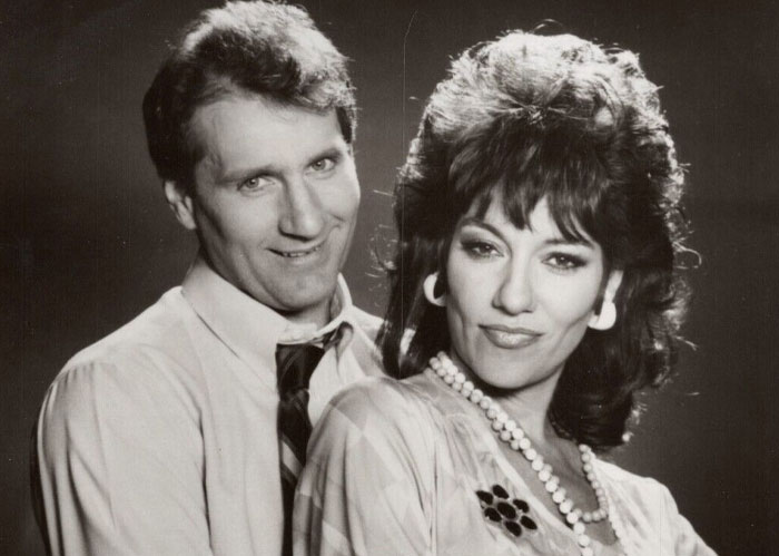 Black and white photo of actors Ed O'Neill and Katey Sagal, America facts from pop culture.