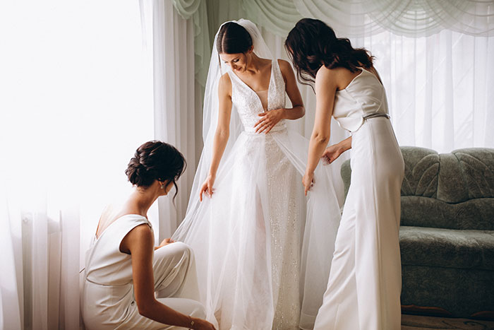 A bride gets ready for her wedding with two bridesmaids, amidst the drama of the groom's mom's behavior.