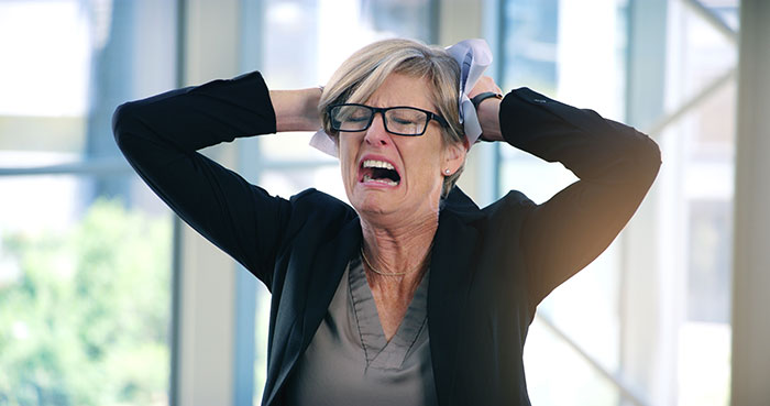 A distraught woman symbolizes the groom's mom reaction to her family being banned from the wedding.