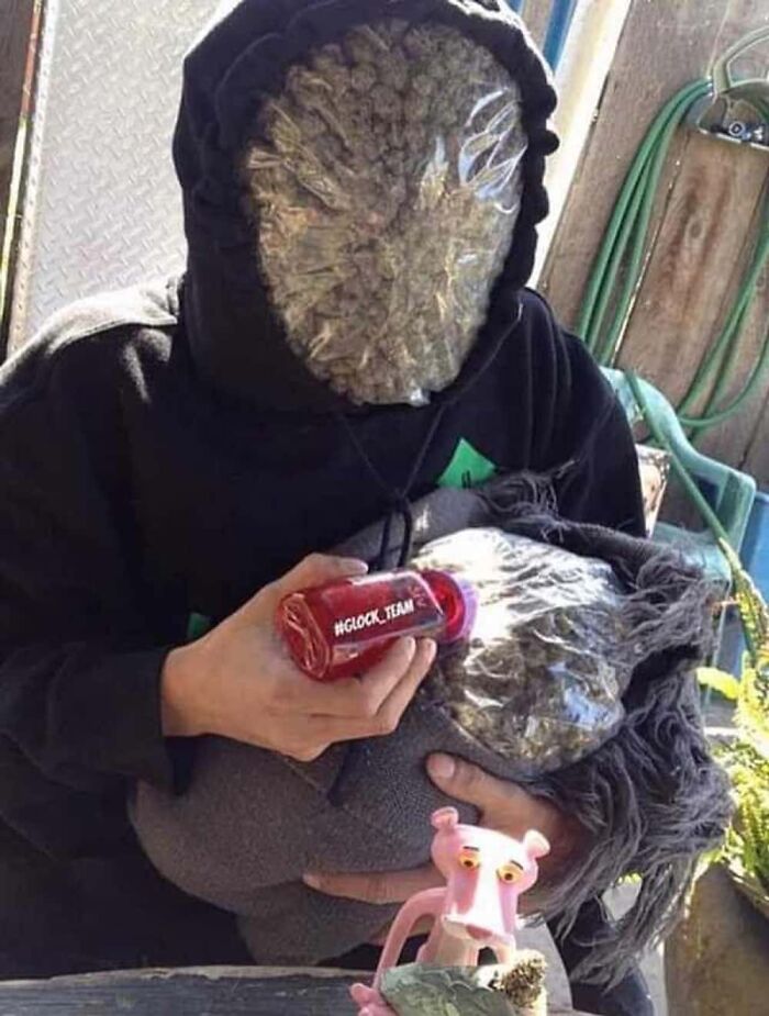 A person with a creepy mask made of m*******a and holding a baby doll, representing confusing images.
