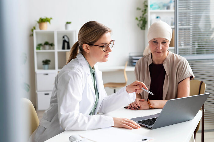 A doctor and patient discussing health, highlighting the impact of childhood experiences on well-being.