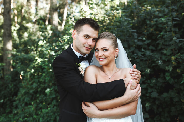 A newlywed couple embracing outdoors, a beautiful, unforgettable childhood experience.