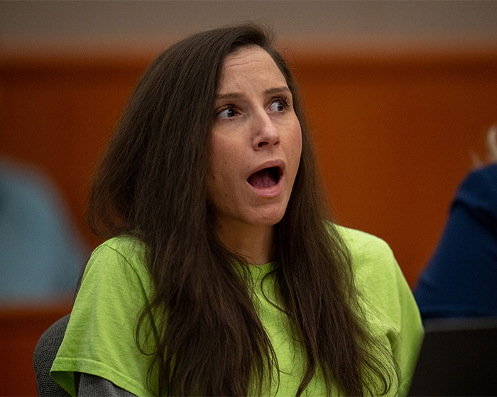 A woman with long dark hair, mouth agape, portraying the shock of terrifying criminal cases and the human mind.