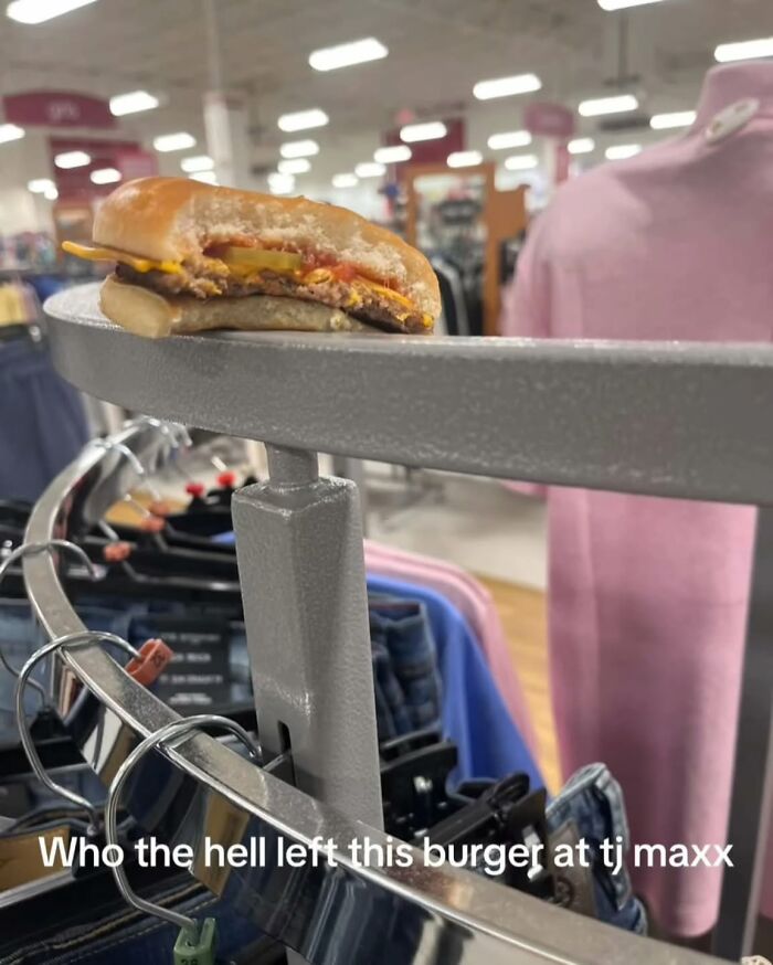 A partially eaten burger left on a clothing rack in TJ Maxx, a painfully cringe post.