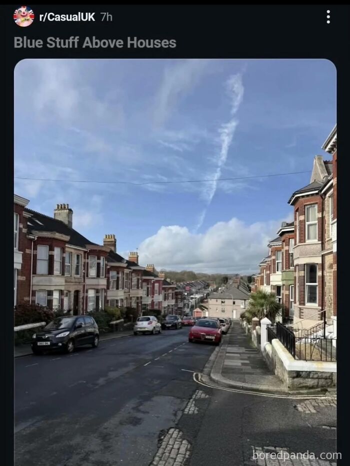A cringe post of Blue Stuff Above Houses, showing a neighborhood street with residential buildings under a uniquely streaked sky.