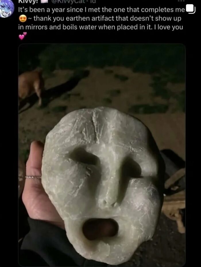 A cringe post on X (Twitter) showing a person holding a strange artifact with a surprised expression.