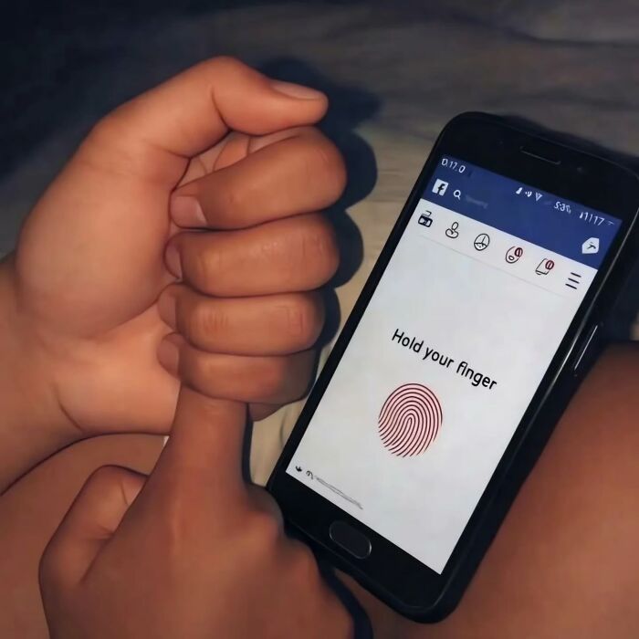 A finger held to a phone screen for fingerprint unlock, a cringe post illustrating technology use.