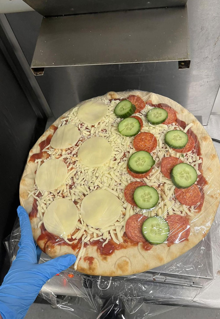A pizza with unconventional toppings of cucumbers and pepperoni, one of 65 camera roll photos.