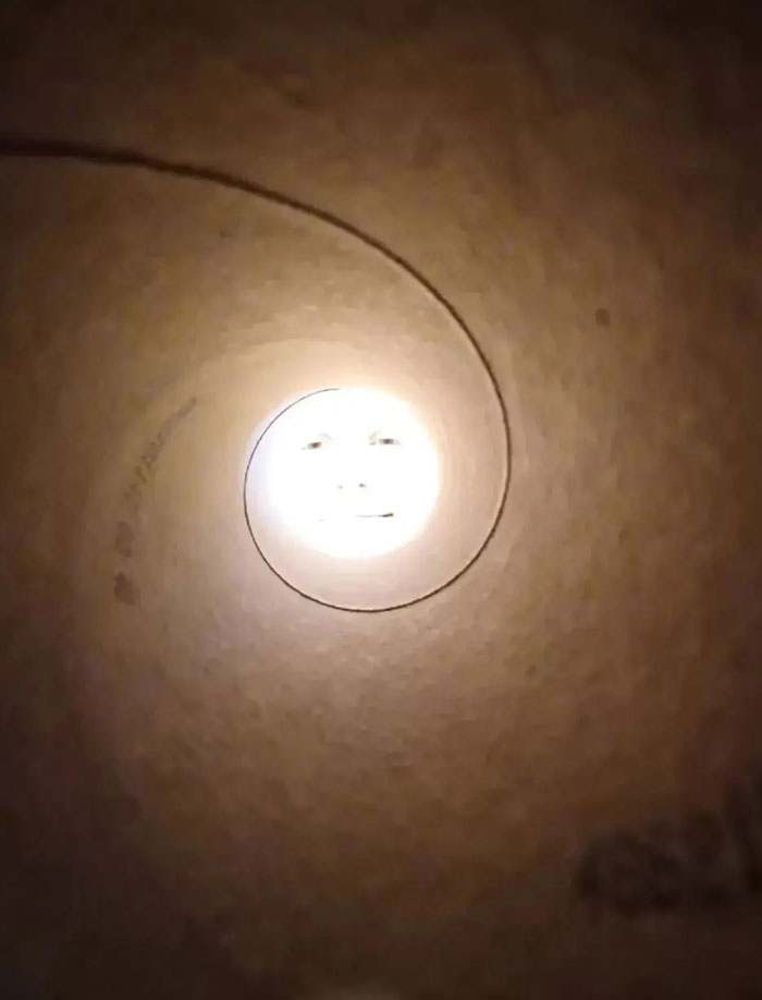A camera roll photo of a face at the end of a long, spiraling tube, needing no explanation.