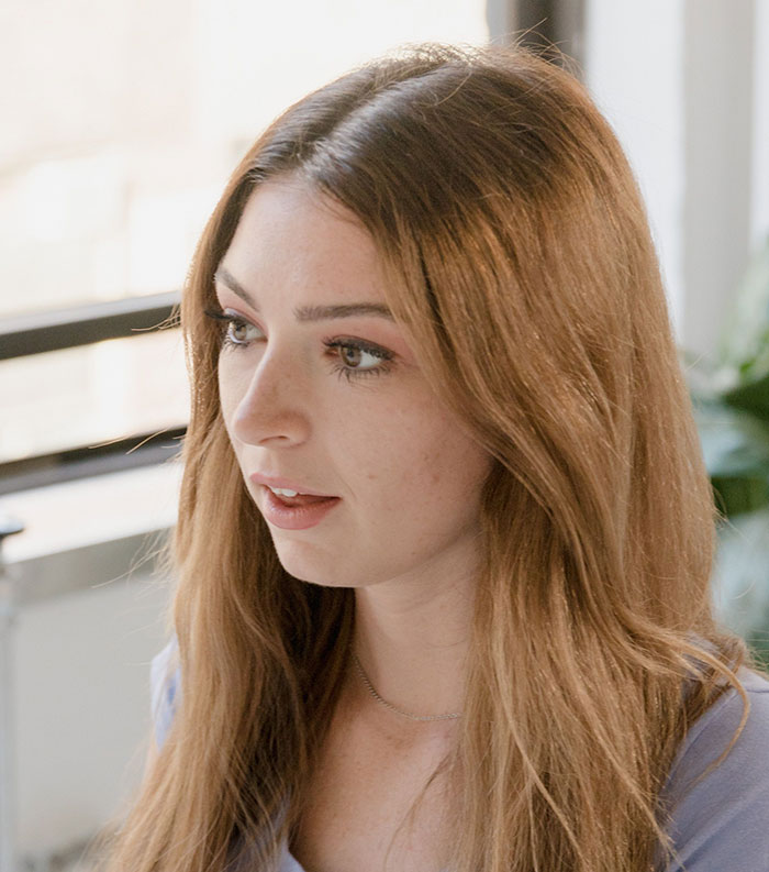 A young woman looking thoughtfully to the side, representing individuals experiencing culture shocks in relationships.