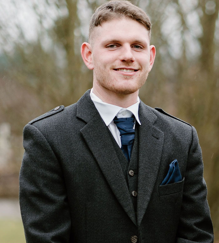 A man in a suit, perhaps representing a formal occasion or cultural event in intercultural relationships.