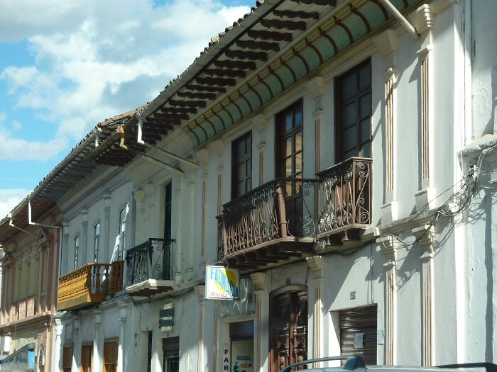 Travelers experiencing culture shock from differences in architecture and a street with old buildings in an unfamiliar city.