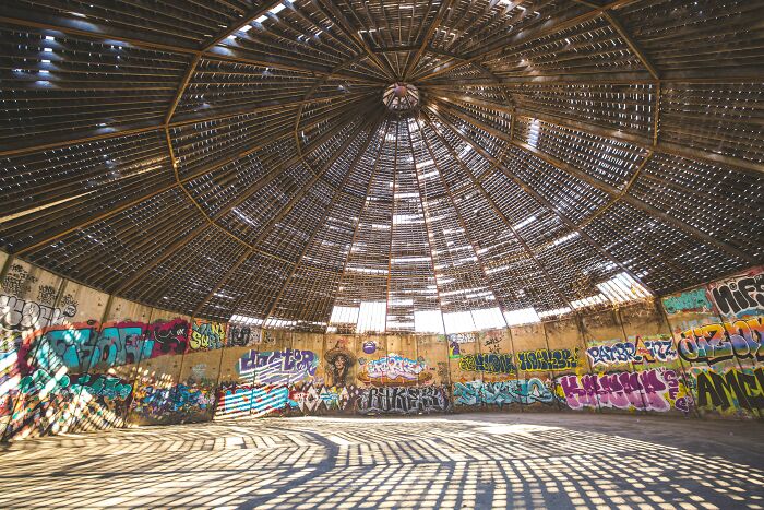 An abandoned dome structure covered in graffiti, a stark contrast for travelers experiencing culture shock.