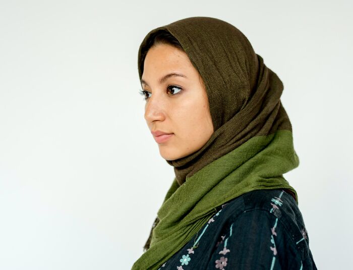 A young woman wearing a green hijab, representing international partners and their culture shocks.